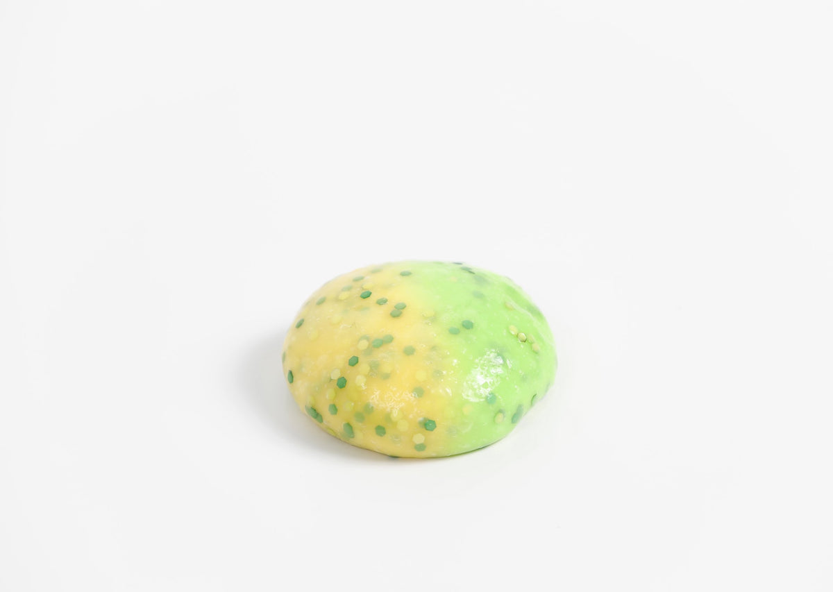 Round ball of Messy Play Kit's Dragon slime that changes from yellow to green in the sunlight