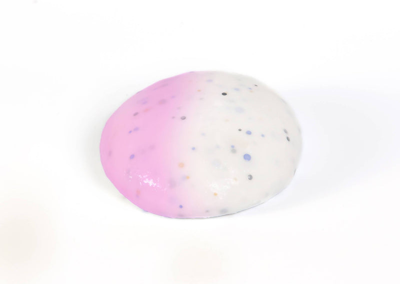 Round ball of  Messy Play Kit's color-changing Unicorn slime that changes from white to pink in the sunlight
