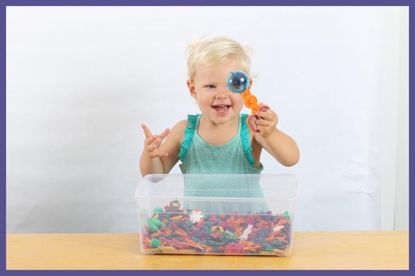Toddler improves her Fine Motor Skills Development with Messy Play bug-themed sensory bin