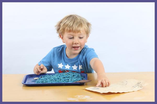 Child learning language skills with messy play kit - Preschool Language Development with Messy Play