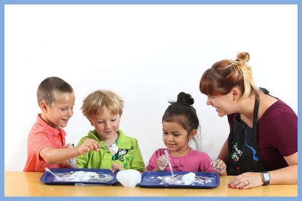 Robin assists 3 children learning science with a messy play kit experiment - Messy Play Teaches Preschool Science Concepts