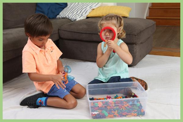 two children explore a sensory bin - Sensory play and brain development