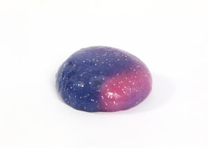 Ball of Messy Play Kit's color-changing Rockstar slime that changes from purple to pink based on temperature.