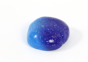 Ball of Messy Play Kit's color-changing Galaxy slime that changes from purple to blue based on temperature.