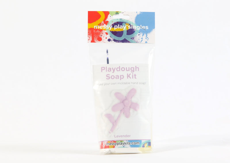 Single package of the Lavender color of Messy Play Kit's playdough soap DIY kit. Label shows a flower molded from the purple playdough soap.