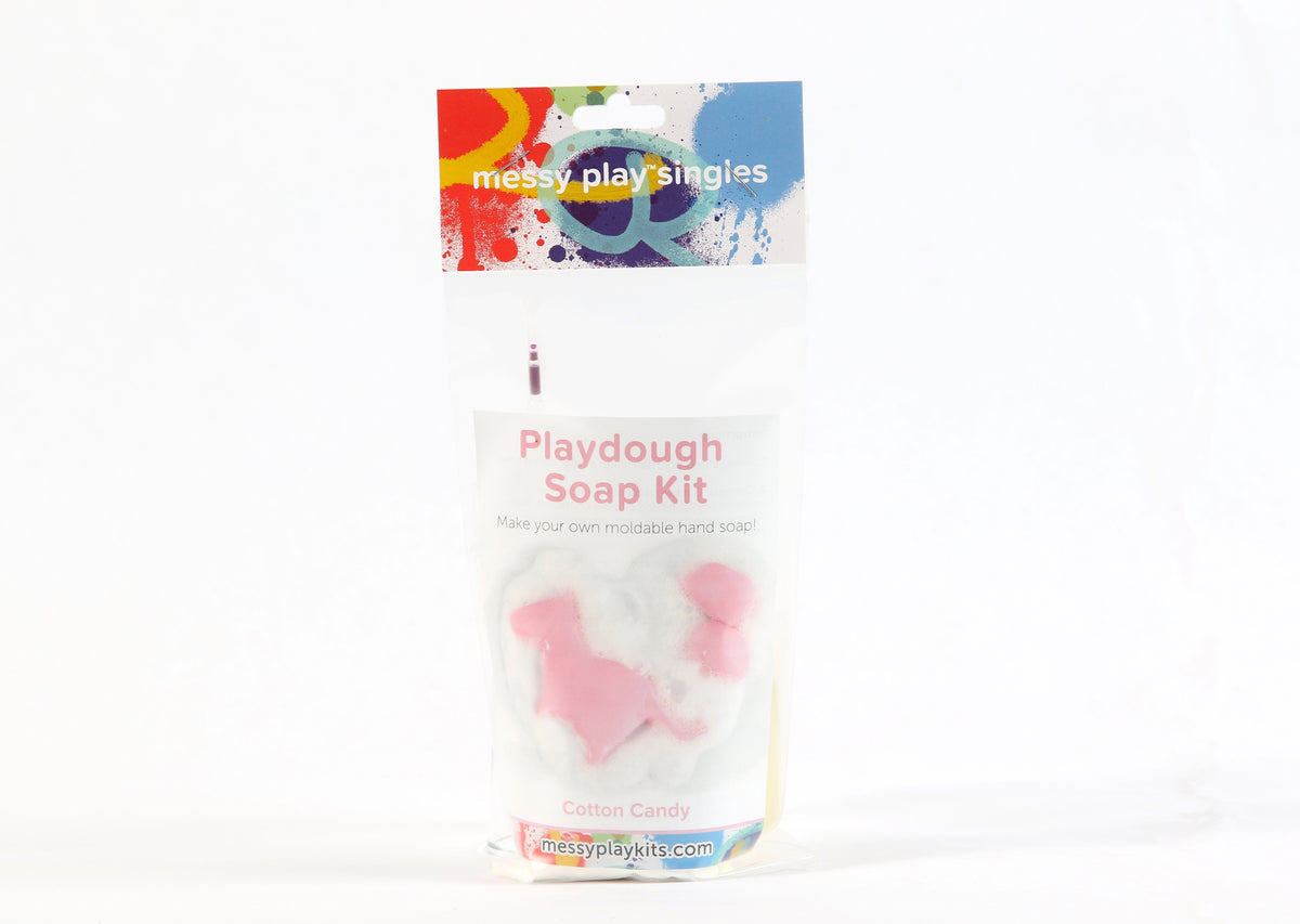 Single package of the Cotton Candy color of Messy Play Kit's playdough soap DIY kit. Label shows a dinosaur molded from the pink playdough soap.