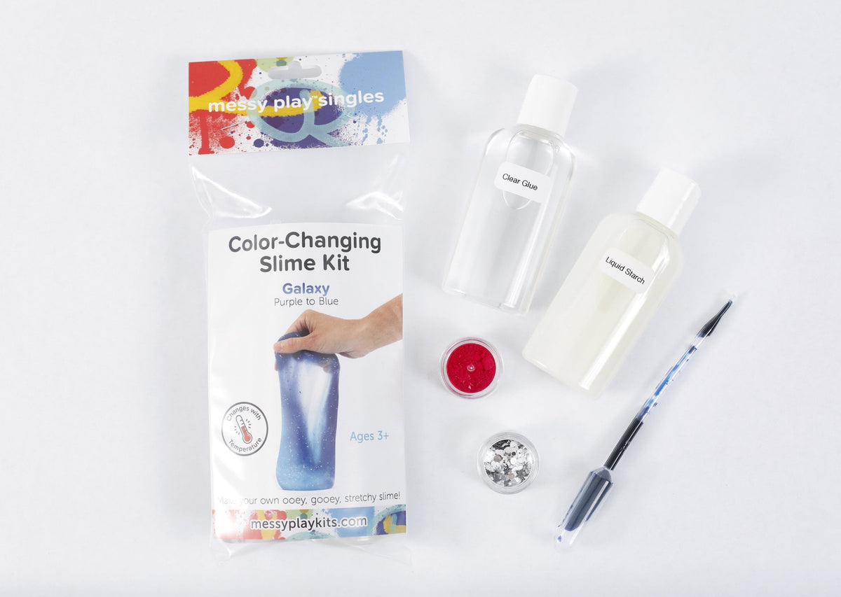Packaging and contents of a Galaxy slime kit, including a glue bottle, liquid starch bottle, glitter, and color-changing pigment that changes the slime from purple to blue based on temperature.