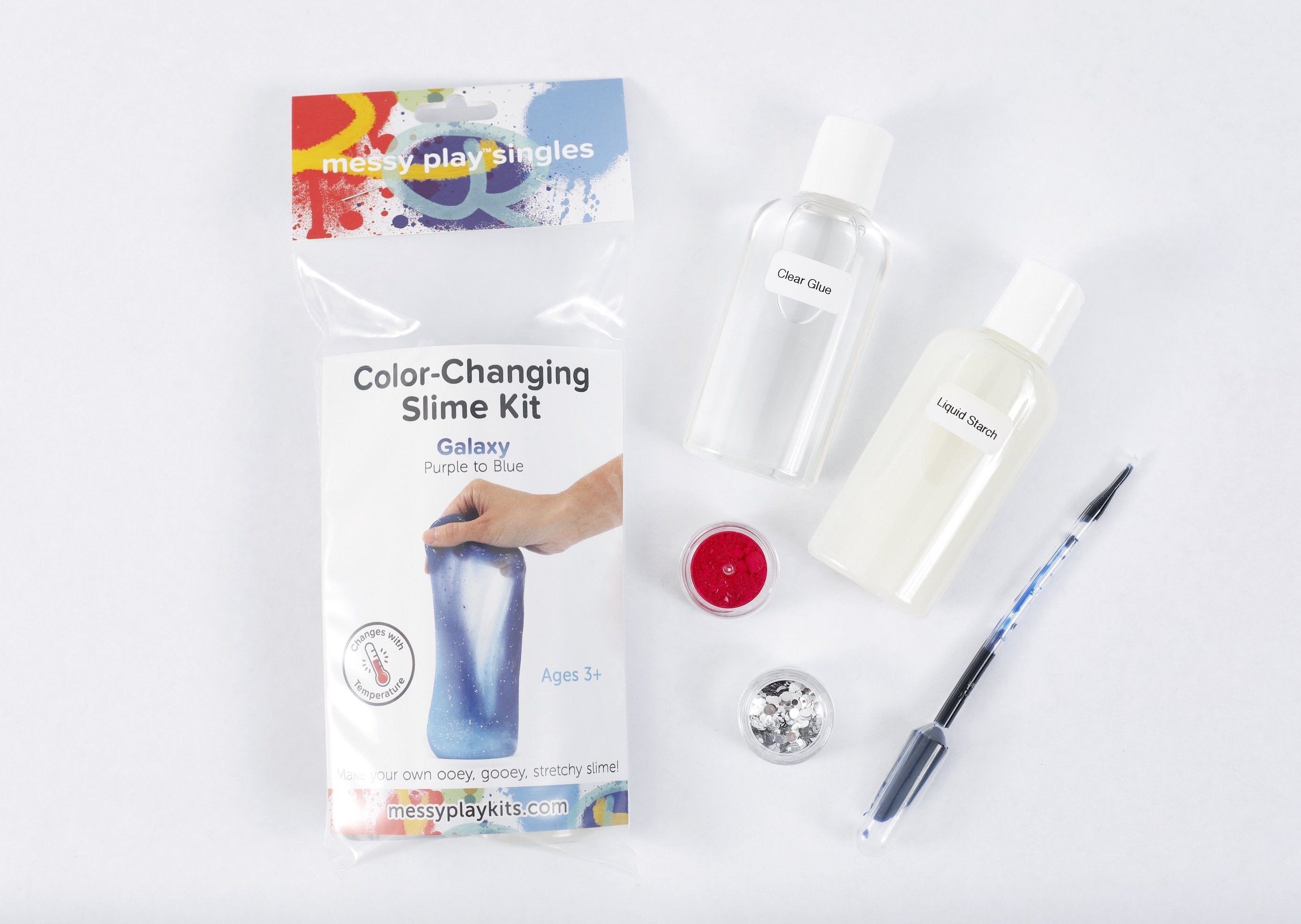 Packaging and contents of a Galaxy slime kit, including a glue bottle, liquid starch bottle, glitter, and color-changing pigment that changes the slime from purple to blue based on temperature.