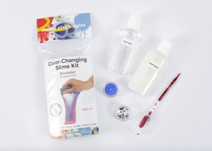 Packaging and contents of a Rockstar slime kit, including a glue bottle, liquid starch bottle, glitter, and color-changing pigment that changes the slime from purple to pink based on temperature.