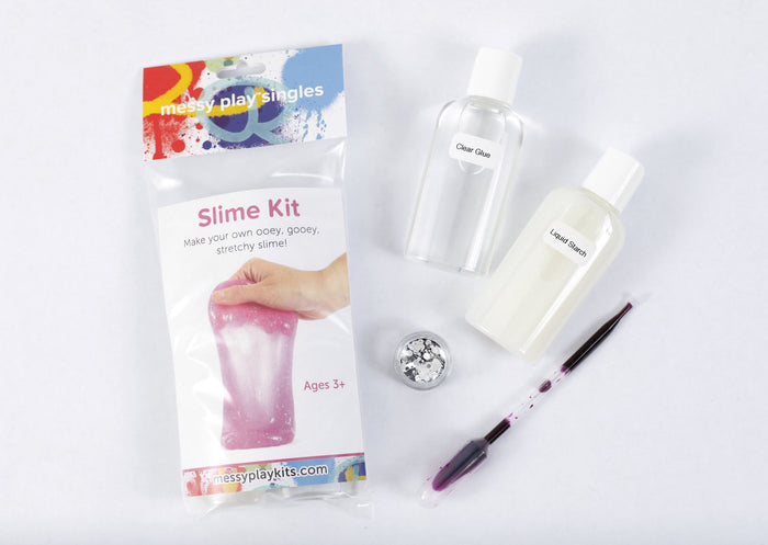 Packaging and contents of a magenta glitter slime kit, including a glue bottle, liquid starch bottle, glitter, and a pipette of color.