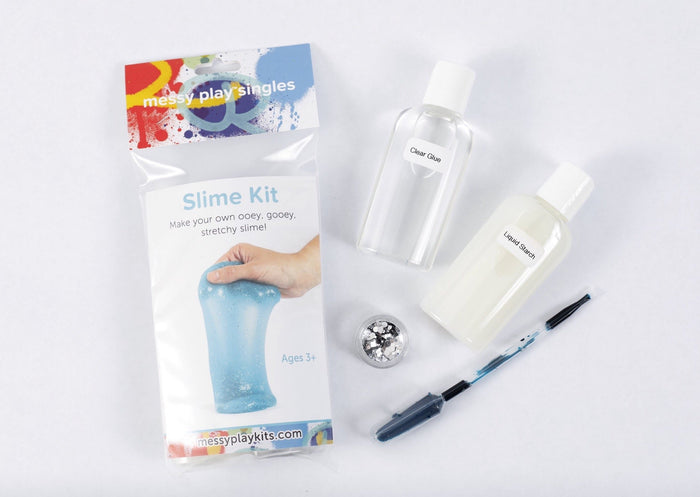Packaging and contents of a turquoise glitter slime kit, including a glue bottle, liquid starch bottle, glitter, and a pipette of color.
