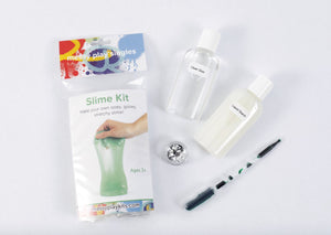 Packaging and contents of a green glitter slime kit, including a glue bottle, liquid starch bottle, glitter, and a pipette of color.