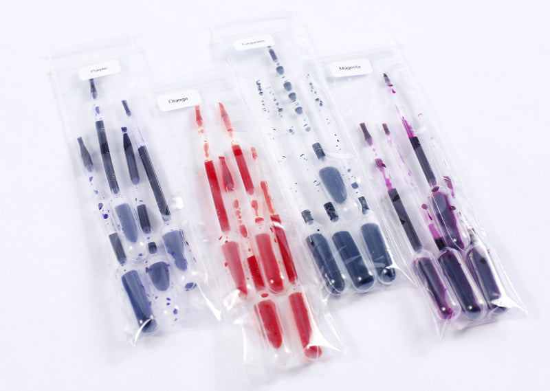 Sixteen pipettes of color, 4 of each color purple, orange, turquoise, and magenta.