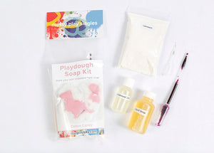 Packaging and contents of a moldable playdough soap kit, including cornstarch, liquid castile soap, sweet almond oil, colorants and fragrance oils.