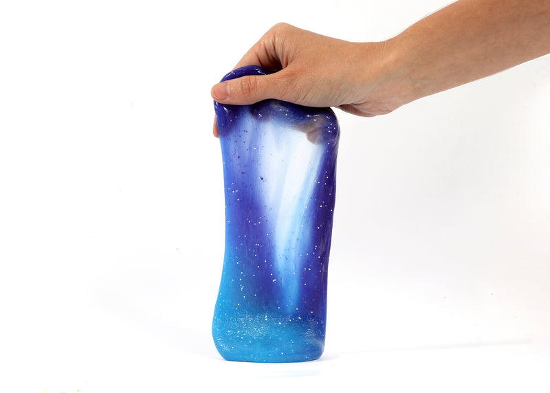 Hand holding Messy Play Kit's color-changing Galaxy slime that changes from purple to blue based on temperature.