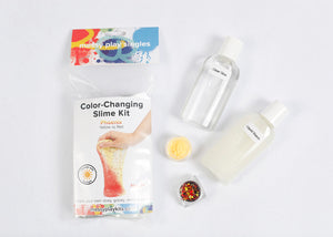 Packaging and contents of a Phoenix slime kit, including a glue bottle, liquid starch bottle, glitter, and color-changing pigment that changes the slime from yellow to red in the sunlight