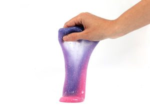 Hand holding Messy Play Kit's color-changing Rockstar slime that changes from purple to pink based on temperature.