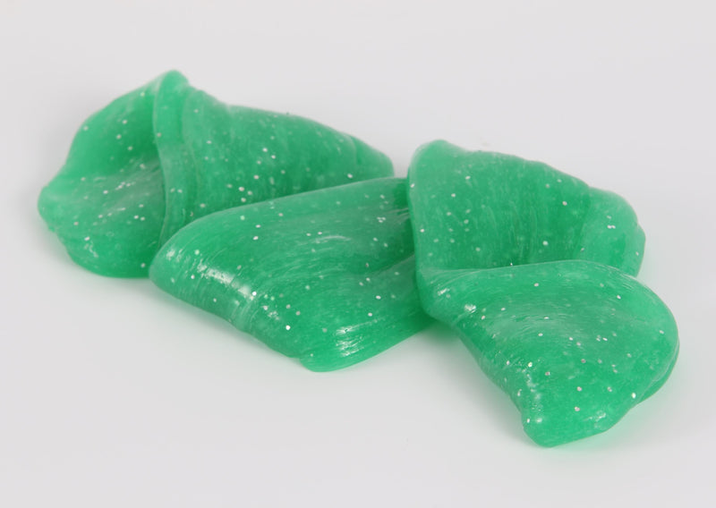 Stretched and folded green glitter slime by Messy Play Kits.