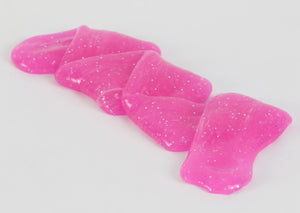 Stretched and folded magenta glitter slime by Messy Play Kits.