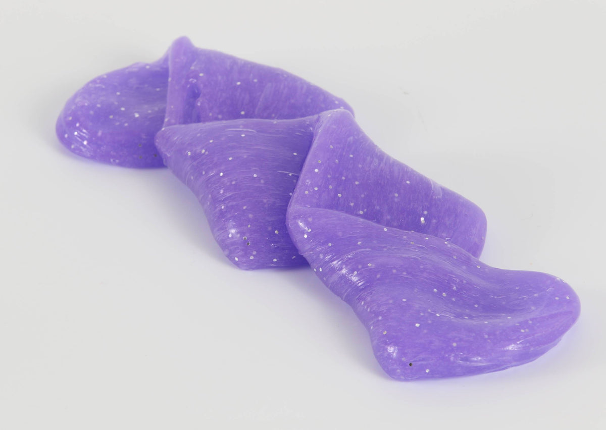 Stretched and folded purple glitter slime by Messy Play Kits.