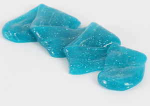 Stretched and folded turquoise glitter slime by Messy Play Kits.