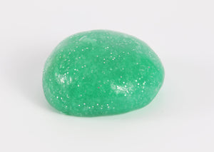 Round ball of green glitter slime by Messy Play Kits.