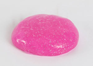 Round ball of magenta glitter slime by Messy Play Kits.