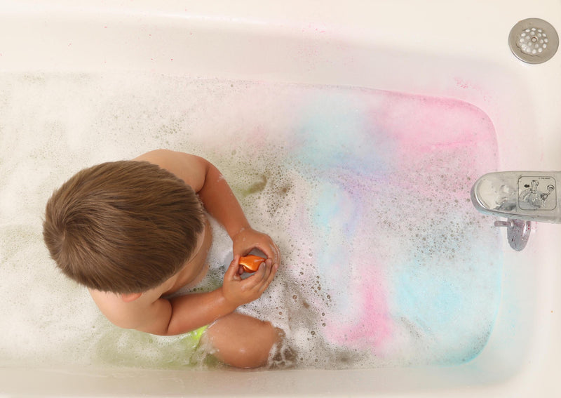 Child in bathtub playing with spray bottle from Bath Tub Fun Messy Play Kit, top view