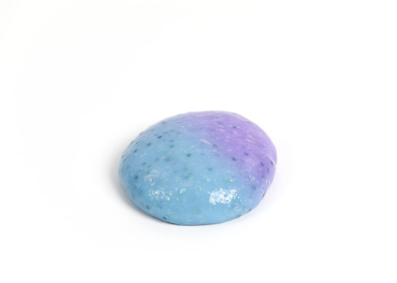Round ball of Messy Play Kit's color-changing Mermaid slime that changes from blue to purple in the sunlight